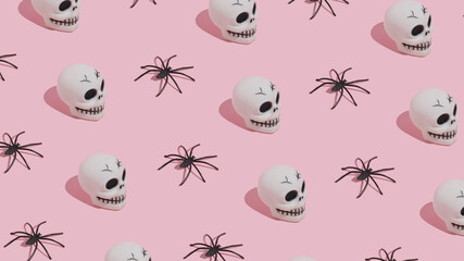 Halloween pattern made of skulls and spiders on pink background. Minimal Halloween concept.
