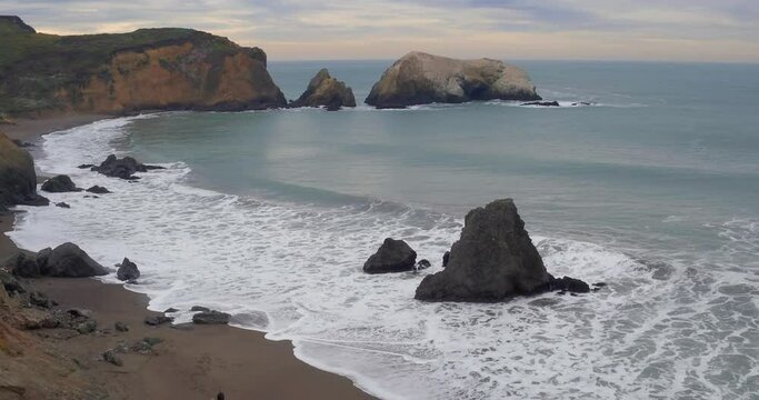 Aerial: Waves crashing on Rodeo beach, Marin, San francisco, USA