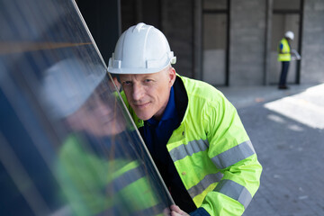 Obraz premium solar power plant engineers and examining photovoltaic panels. Concept of alternative energy and its service. Electrical and instrument technician.