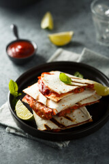 Traditional homemade Mexican quesadilla with tomatoes and cheese