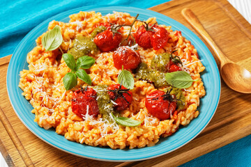 creamy tomato risotto with pesto, top view