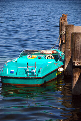 Fototapeta na wymiar classic blue speed boat at pier