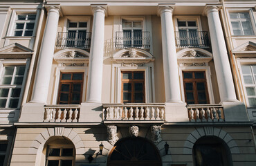 An old classical building with columns on the balconies, windows and mascarons. Lviv, Ukraine.