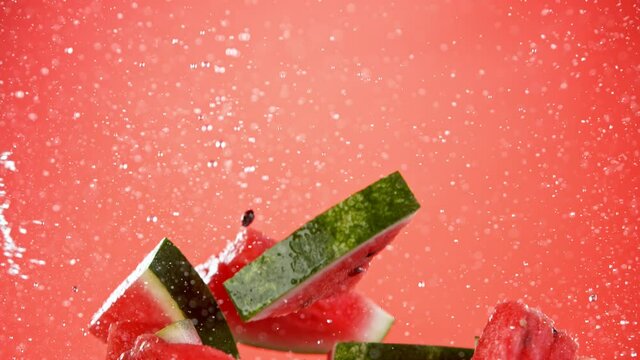 Super slow motion of sliced water melon with water splash flying in the air. Filmed on high speed cinema camera, 1000 fps.