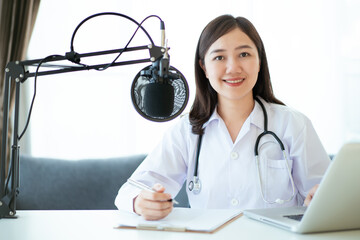 Asian doctor making an online video conference with her patient.