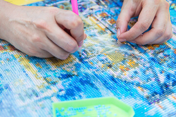 Diamond mosaic painting, Diamond mosaic, fragment of painting close-up, handmade hobby.