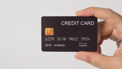 Black credit card in man hand isolated on white background.