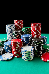 Stack of Casino gambling chips on green table