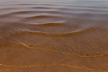 natural background texture of river sand under clear water