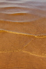 natural background texture of river sand under clear water