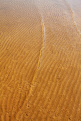 natural background texture of river sand under clear water