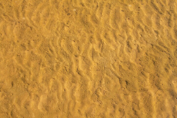 natural background texture of river sand under clear water
