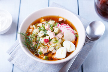 Okroshka with kvass and sausage. Traditional classic cold Russian soup. Close-up.