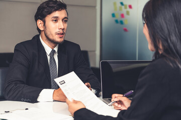Human resource manager interviewing the male employment candidate in the office room. Happy job...