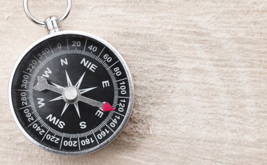 round compass on natural wooden background as symbol of tourism with compass, travel with compass...