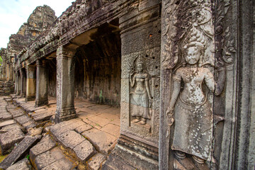 The low relief carvings surrounding Bayon Castle belong to the Khmer Empire. Located in the center of Angkor Thom
