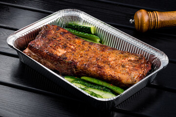BBQ grilled ribs in a metal tray for delivery. Take out concept, eating at home