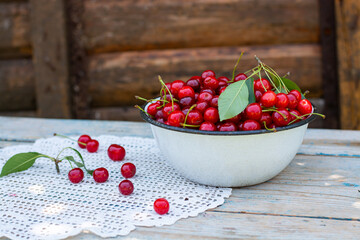 red ripe cherries in a plate on the table