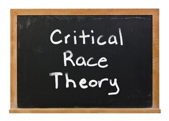 Critical race theory written in white chalk on a black chalkboard isolated on white