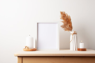 Home decoration with white mock up frame on table. Artwork showcase. Scandinavian style, copy space