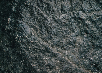 Texture of rough black stone close-up. Dirty granite. Natural background.