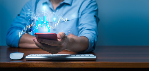 Businessman using smartphone for analysis business data graph growth and analyzing financial data on hand. Technology of Business Planning and Strategy