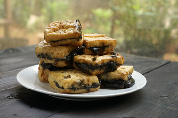 Tahu petis is Javanese traditional snack made from fried tofu with black shrimp paste or petis.