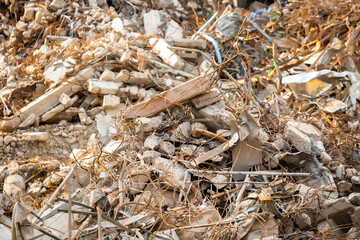 Scrap iron and cement remains from building demolition on a demolishion site.