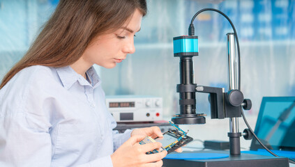 A young woman is experimenting with Lan on Chip devices. Microfluidics device