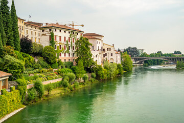 Fototapeta na wymiar View from the old bridge of the city of Bassano del Grappa on the Brenta river, Vicenza - Italy