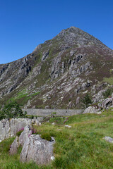 Fototapeta na wymiar Pen Yr Ole Wen mountain with the A5 road in the Snowdonia National Park, North Wales. On a summers day with blue sky