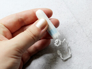 Hygienic female tampon in a woman's hand