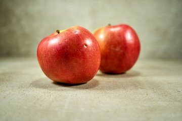 Red apples on the grey background