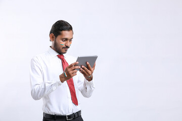 Young indian businessman or employee using smartphone.