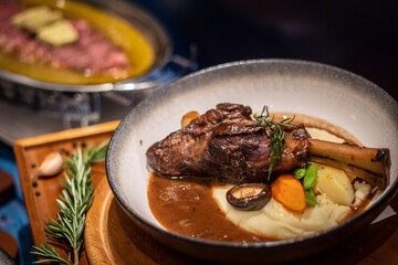 lamb meal with potato on wooden board with rosemary