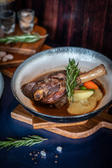 lamb meal with potato on wooden board with rosemary