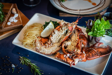 Grilled canadian lobster serve with butter chilli sauce with lemon and salt.