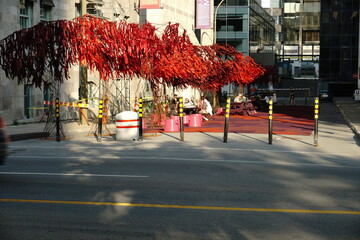 Montreal, QC, Canada - 7-14-2021: The Urban Forest at the street next to McCord museum, Sherbrooke street west with people enjoying their time after the ease of the lockdown of coronavirus. Green Zone
