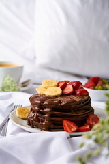 chocolate pancakes with banana and strawberry