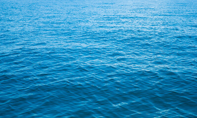 Blue water with sun reflections