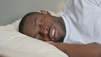 Fototapeta na wymiar Young African Man Snoring in Bed, Sleeping 