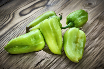 Freshly picked, home-grown fresh green peppers on rustic wooden background