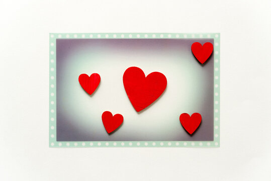 themed photo overlay with five hand-painted wooden hearts on a light background and plenty of space for copy or text