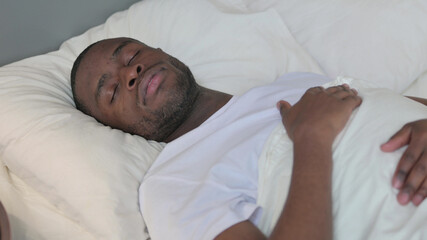 Relaxed Young African Man Sleeping in Bed 