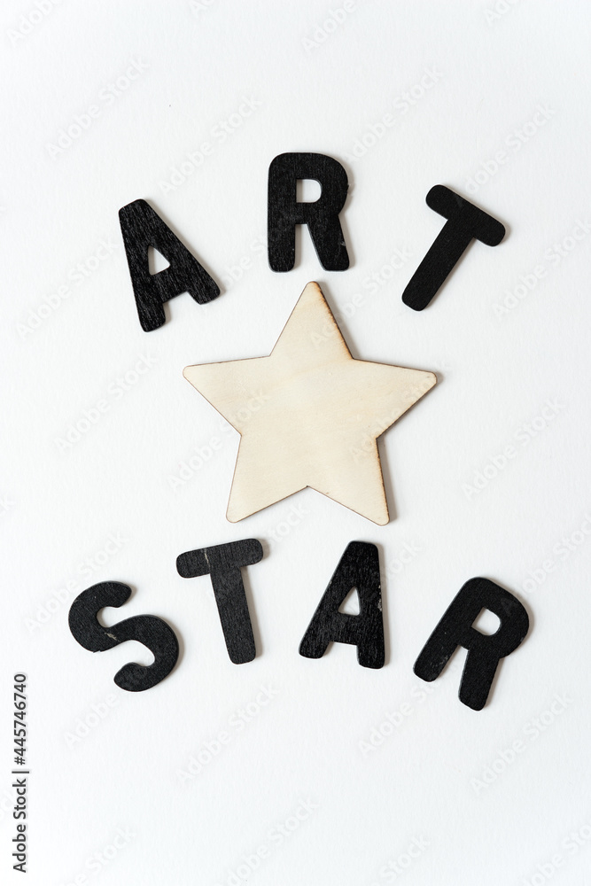 Canvas Prints art star in black chalk letters and a plain wooden star on a white background