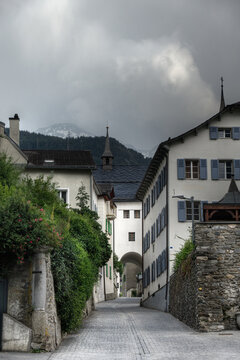 View in the Alte Simplonstrasse, a beautiful street in the old Swiss city brig, in the background te mountains