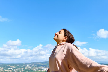 Teenage girl breathing deeply outdoors