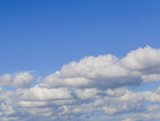 Fototapeta na wymiar Background of white summer clouds on blue sky.