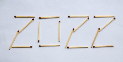 The numbers 2022 are laid out of fire matches with red heads. Happy New Year Concept