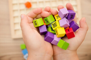 Mats educational game. To develop fine motoric skills, logical thinking, tool for primary school pupils and aspiring maths pros. Colorful wood cubes with numbers, digits, basic arithmetic operations